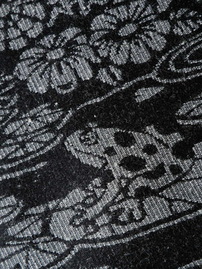 Close up of black fabric with grey frog