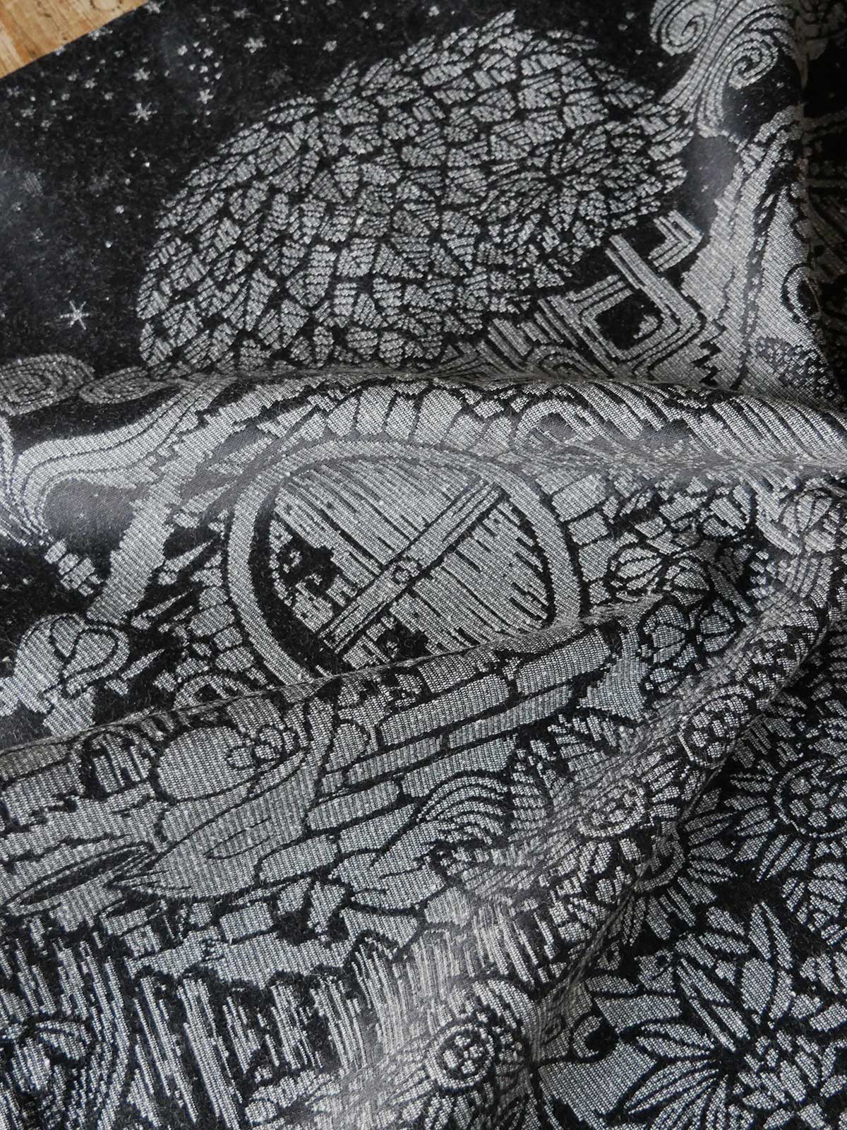 Close up of black fabric with grey details of a garden