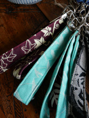 Close-up of fabric keychains with different patterns on a wooden surface
