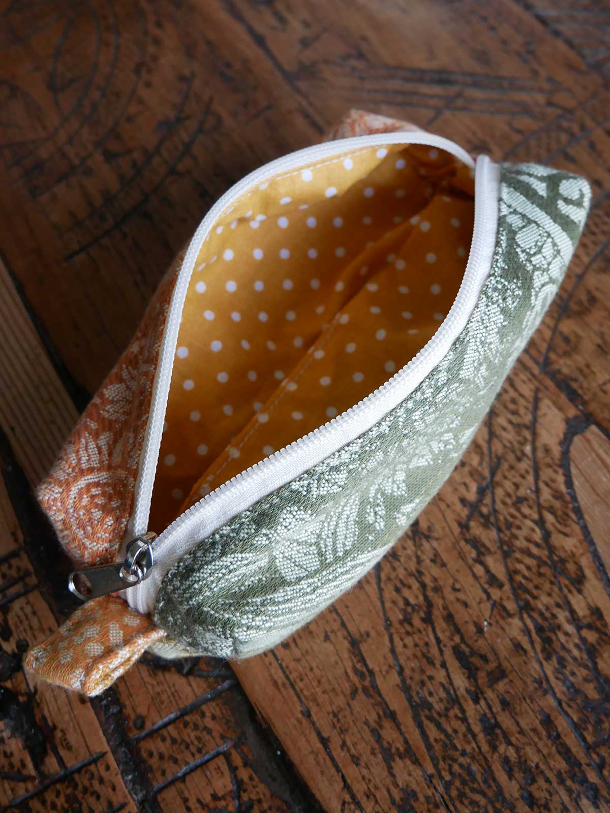 Fabric pouch with zipper on a wooden surface