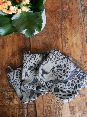 Anima print zip pouches on wooden table. 