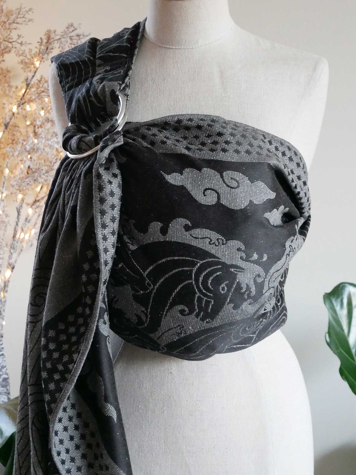 Mannequin wearing a black and gray Kelpies Stormy Seas Ring Sling.