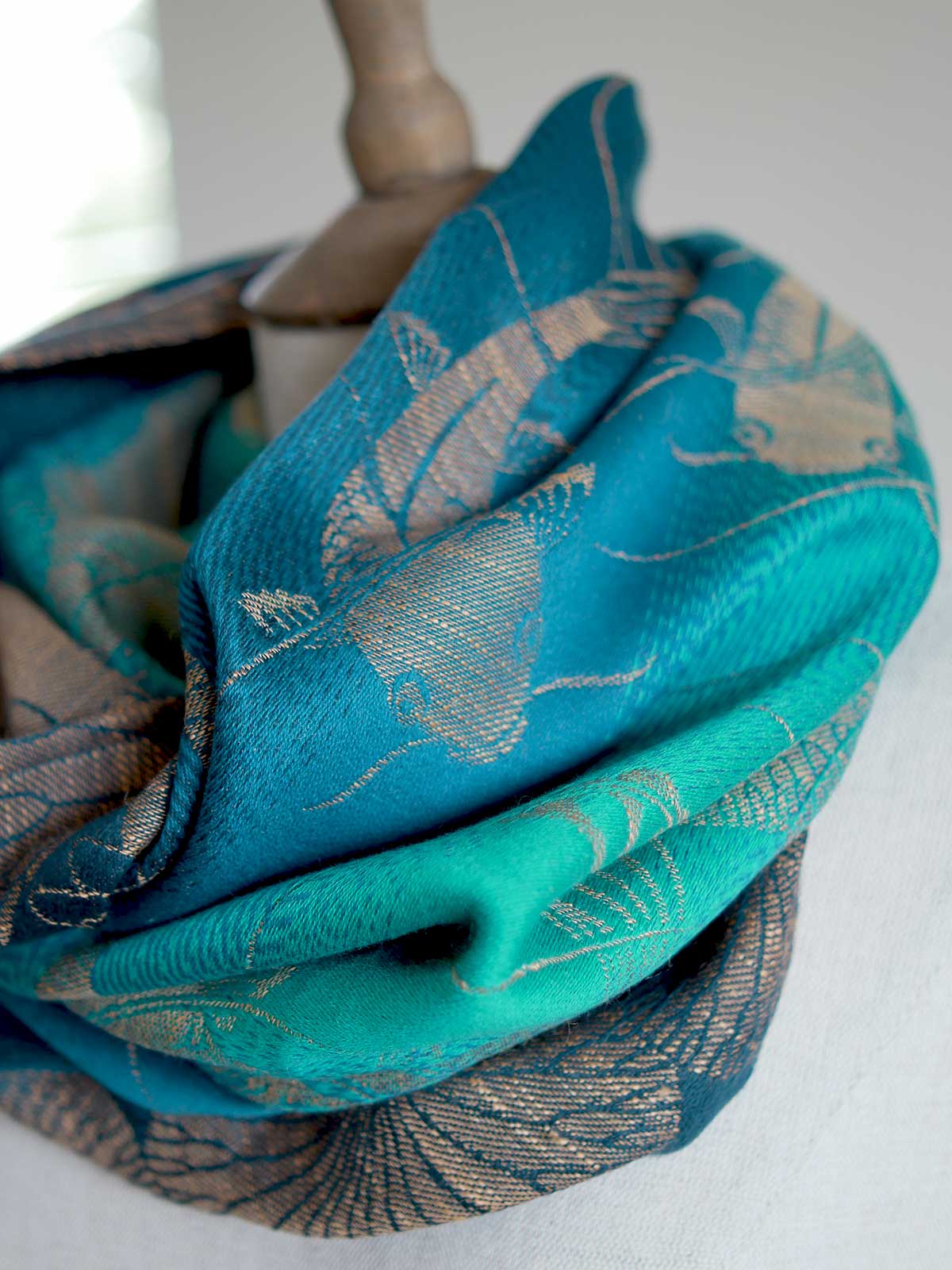 SIde view of Koi Moire cowl in teal