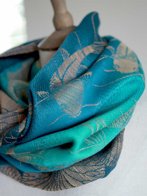 SIde view of Koi Moire cowl in teal