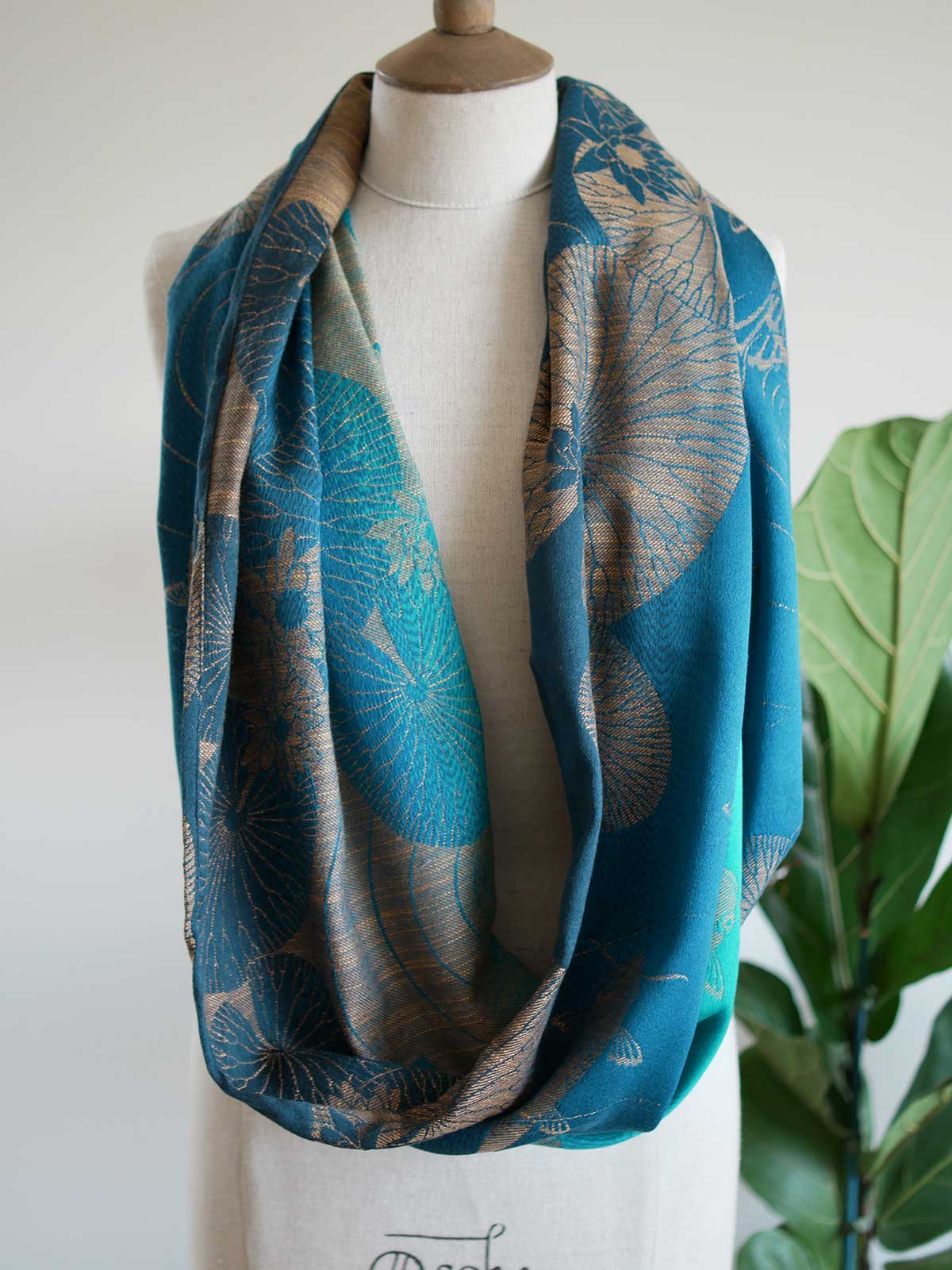 Front view of Koi Moire infinity loop in teal on a mannequin