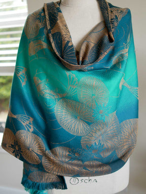 Koi Moire scarf in teal drapped on a mannequin