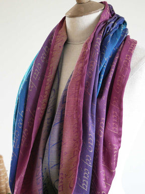 Mannequin wearing a colorful scarf with text on a white background