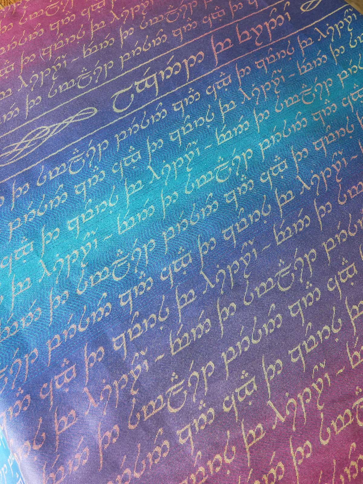 Text in elven script on a gradient background