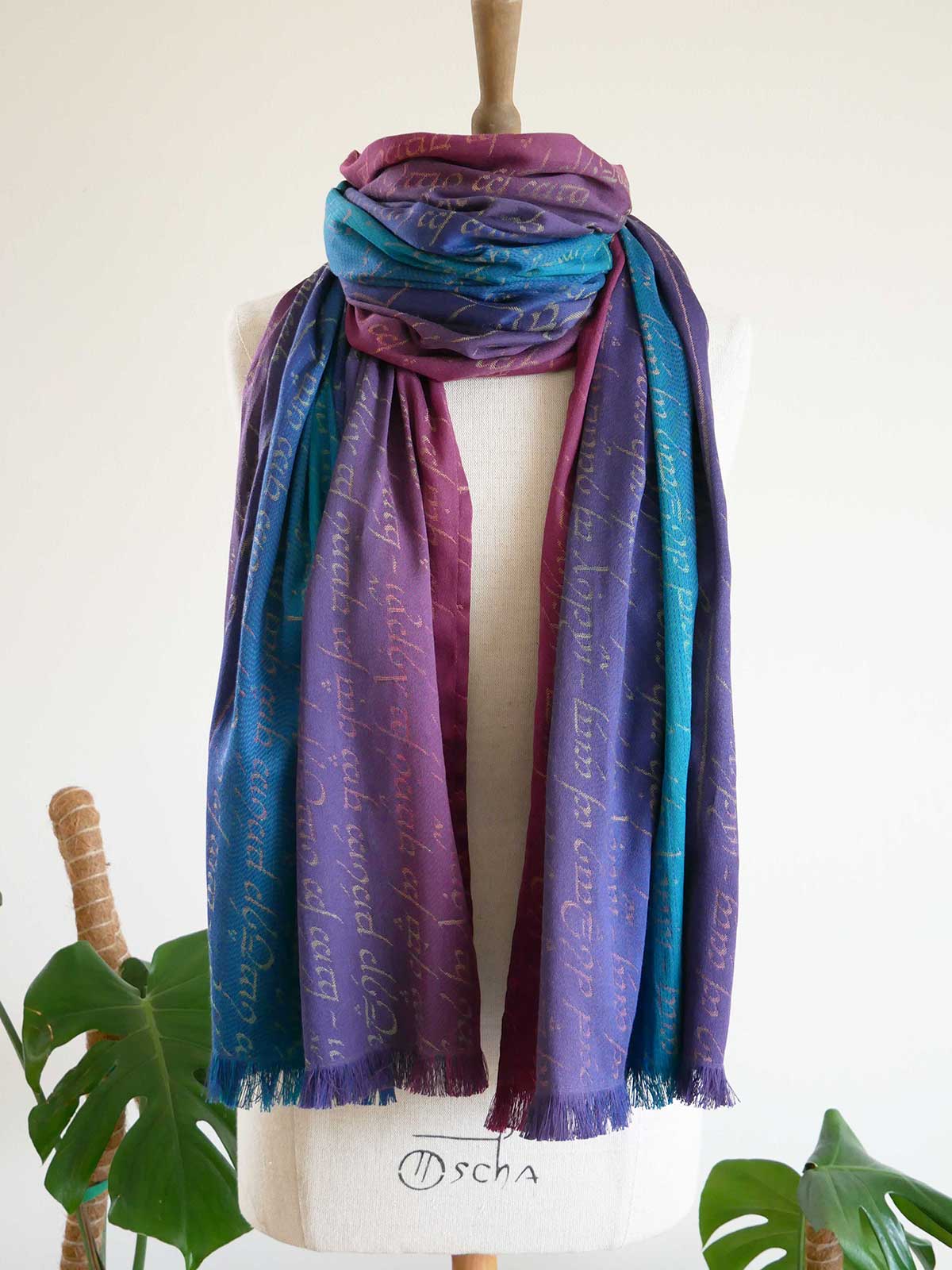 Colorful Legend of Frodo Dreme Scarf with text on a mannequin against a white background