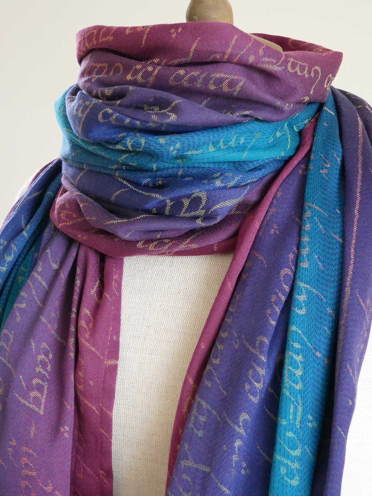 Multicolored scarf with text pattern on a mannequin against a white background