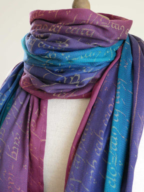 Multicolored scarf with text pattern on a mannequin against a white background