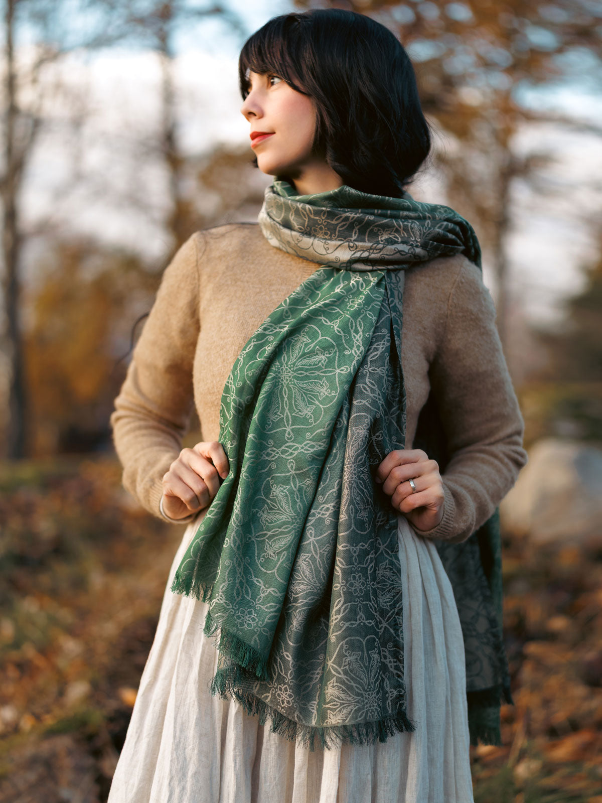 Woman wearing a green scarf in a forest setting