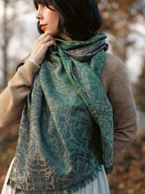 Woman wearing a green patterned scarf in an outdoor setting