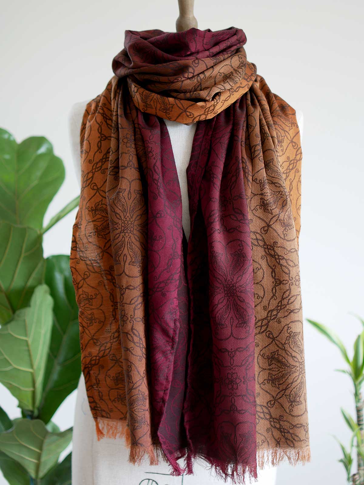 Red and carmel colouted scarf on a mannequin.