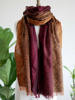 Red and carmel colouted scarf on a mannequin.