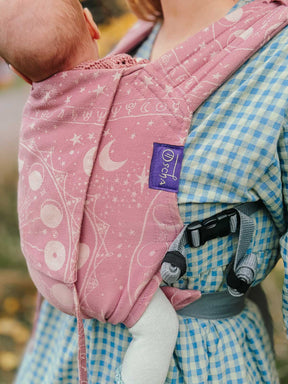 Detail of Bairn carrier in dusky pink with grey straps.