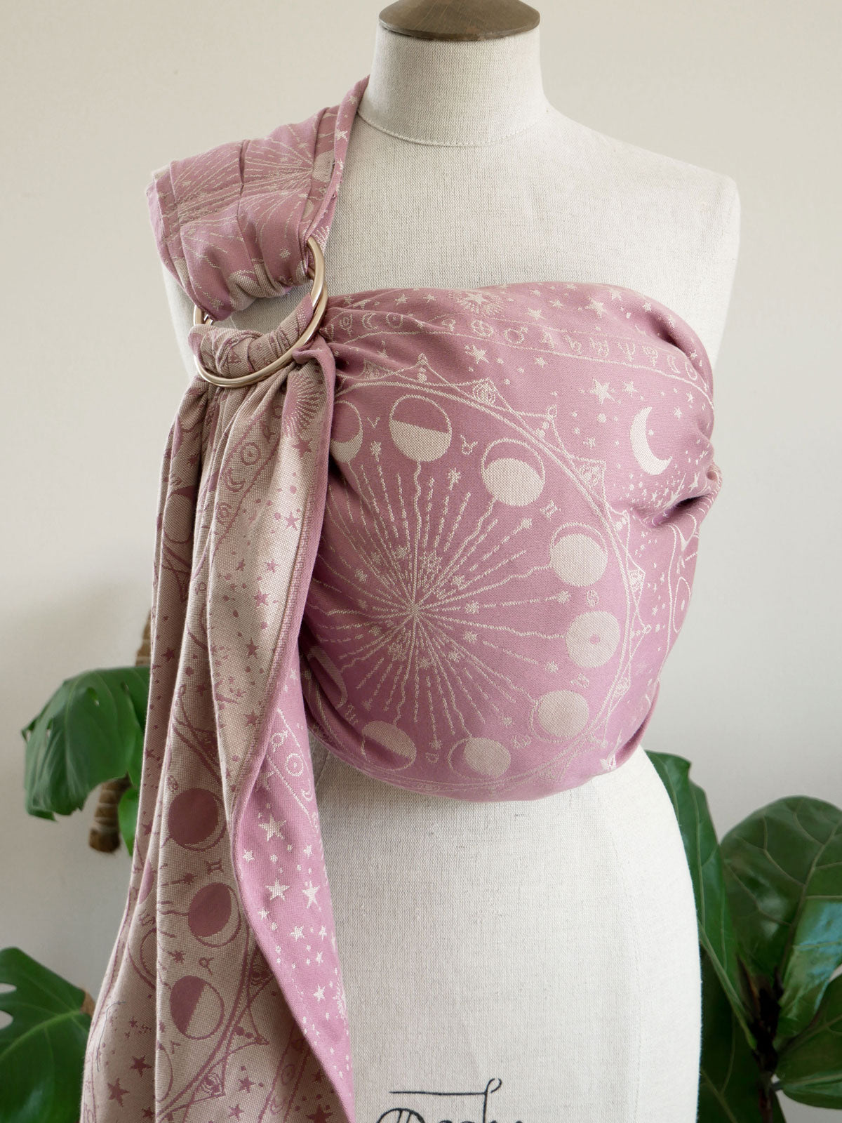 Pink ring sling with celestial pattern on a mannequin against a neutral background