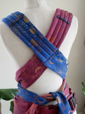 Blue and purple fabric straps on a mannequin with a white background
