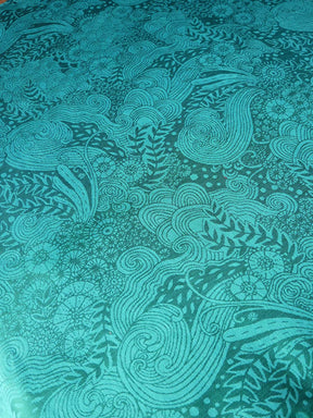 Teal fabric with intricate underwater pattern