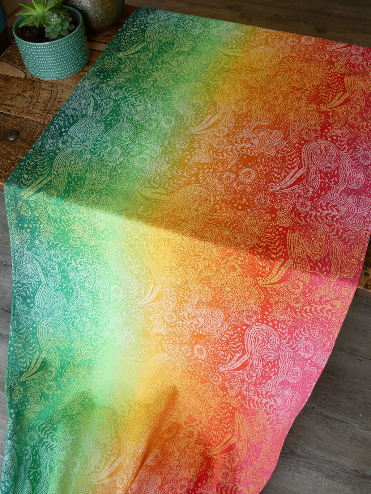 Colorful fabric with a gradient pattern on a wooden surface