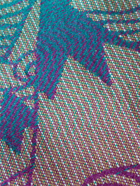 Close-up of a textured fabric with purple and green patterns