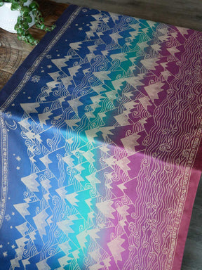 Colorful fabric with mountain patternon a wooden surface