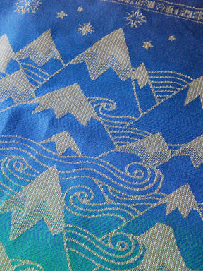 Textile with blue and silver mountain and wave pattern