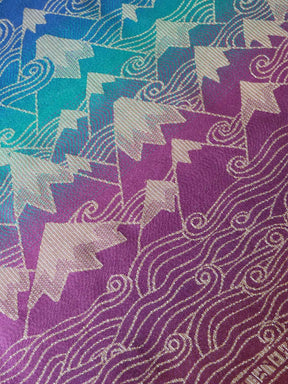 Patterned fabric with star and cloud design in purple, blue, and green.