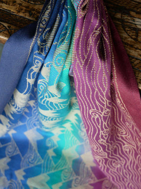 Close-up of colorful fabric with intricate patterns in blue, green, and purple.