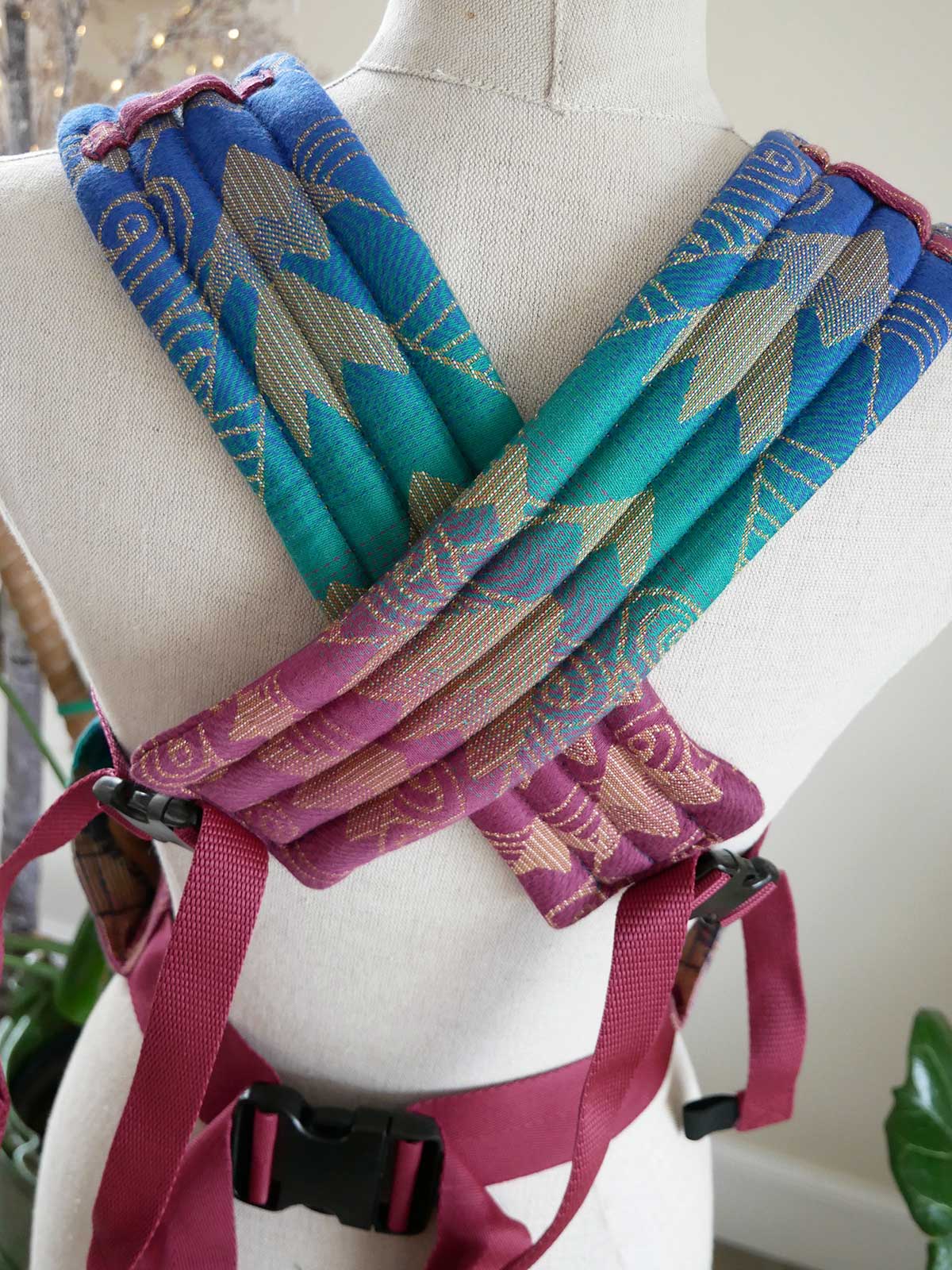 Colorful fabric baby straps on a mannequin with a white background