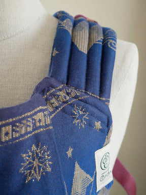 Blue fabric with gold patterns on a mannequin arm
