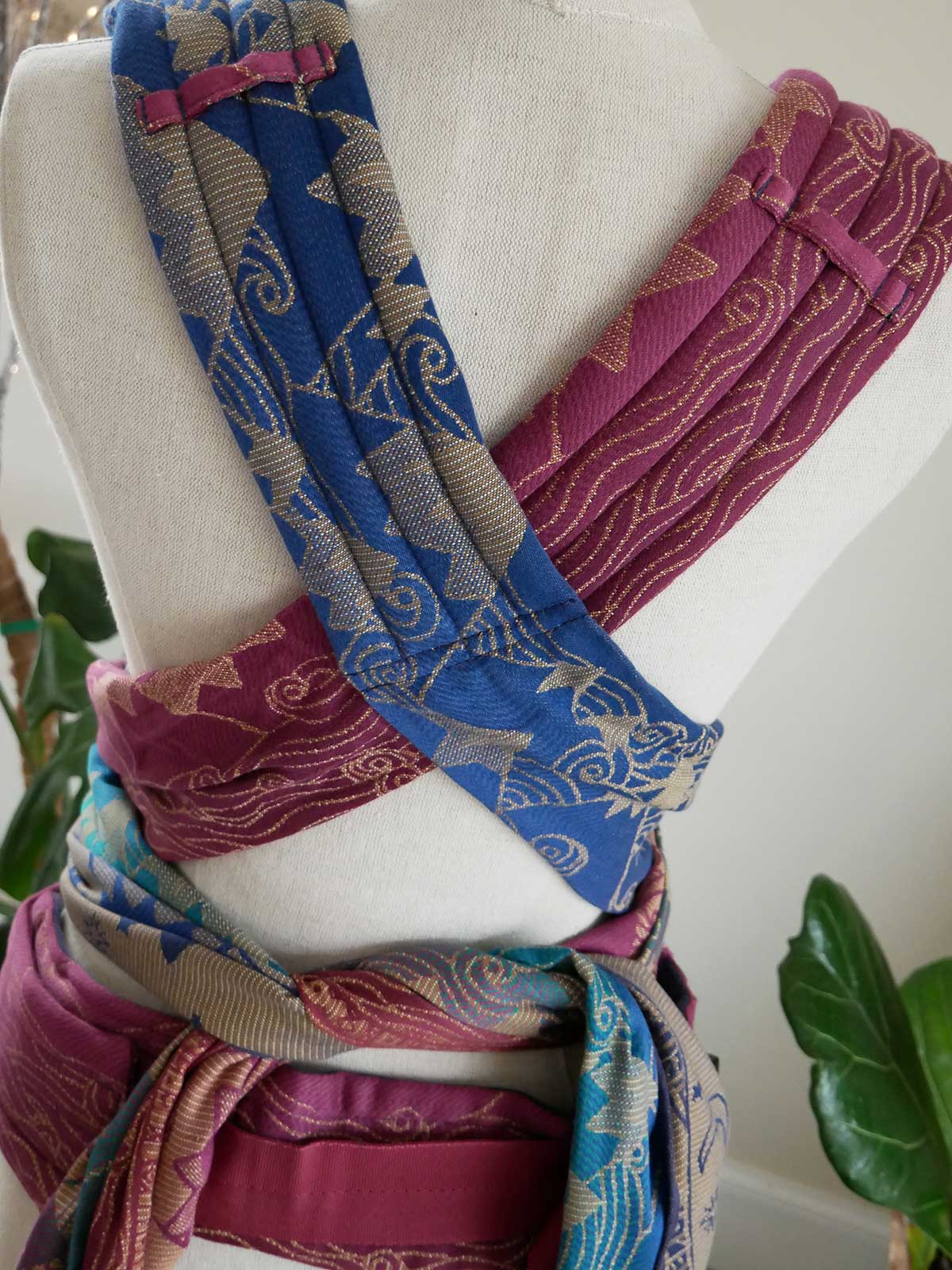 Colorful fabric straps on a mannequin with a white background