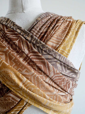 Textured fabric with patterns draped over a mannequin on a white background