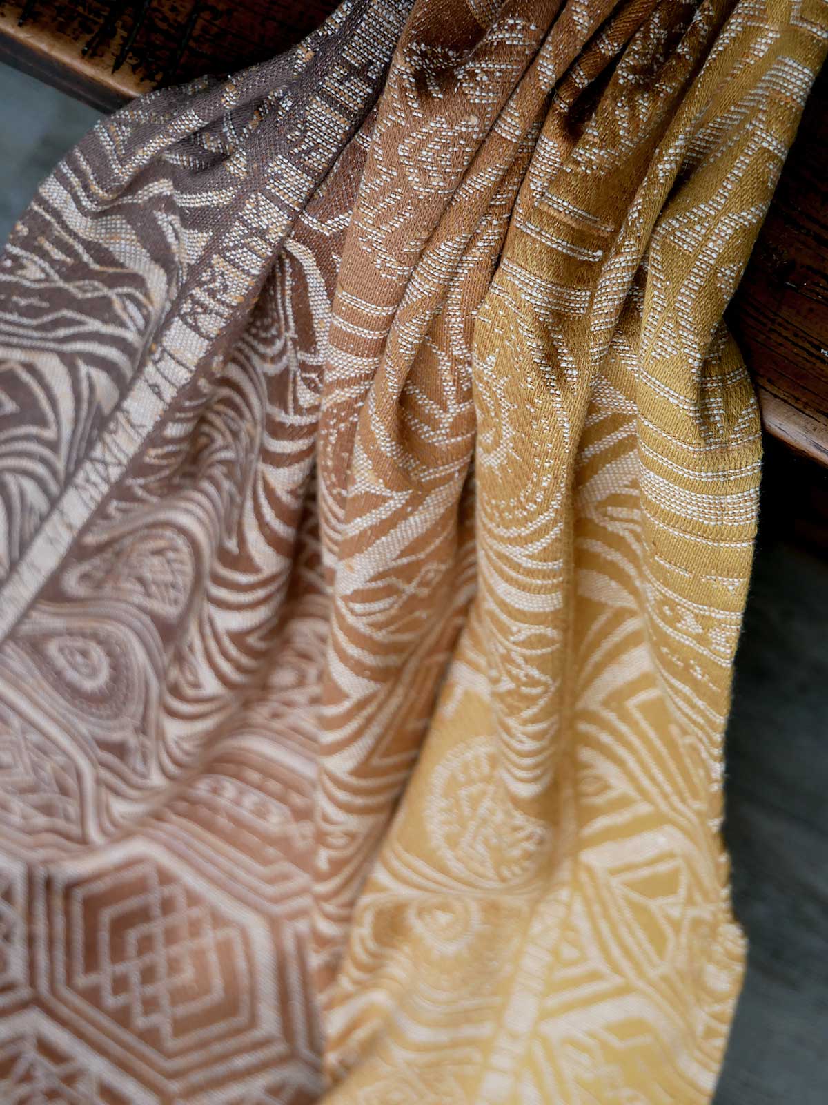Close-up of patterned fabric in brown and yellow tones.