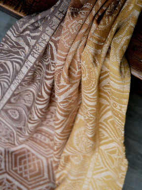 Close-up of patterned fabric in brown and yellow tones.