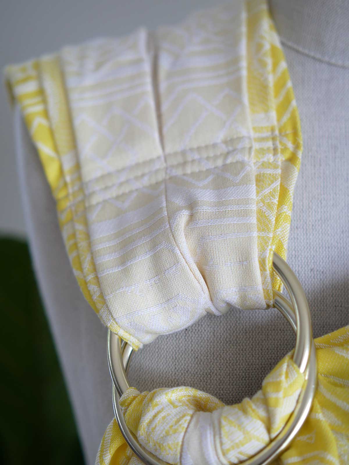 Close up of  a yellow ring sling with geometric pattern on a mannequin