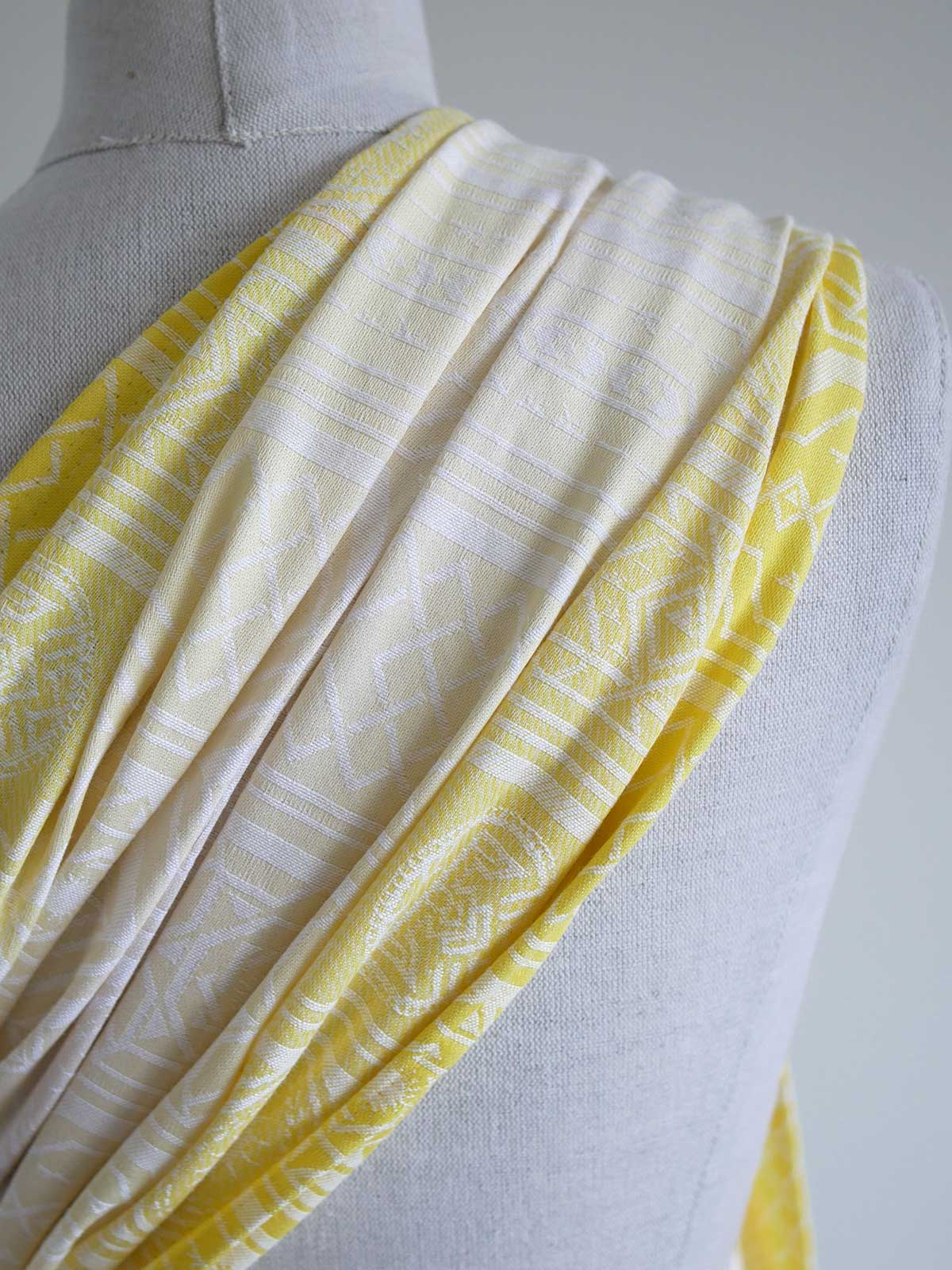 Close up of  a yellow ring sling with geometric pattern on a mannequin