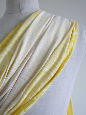 Close up of  a yellow ring sling with geometric pattern on a mannequin