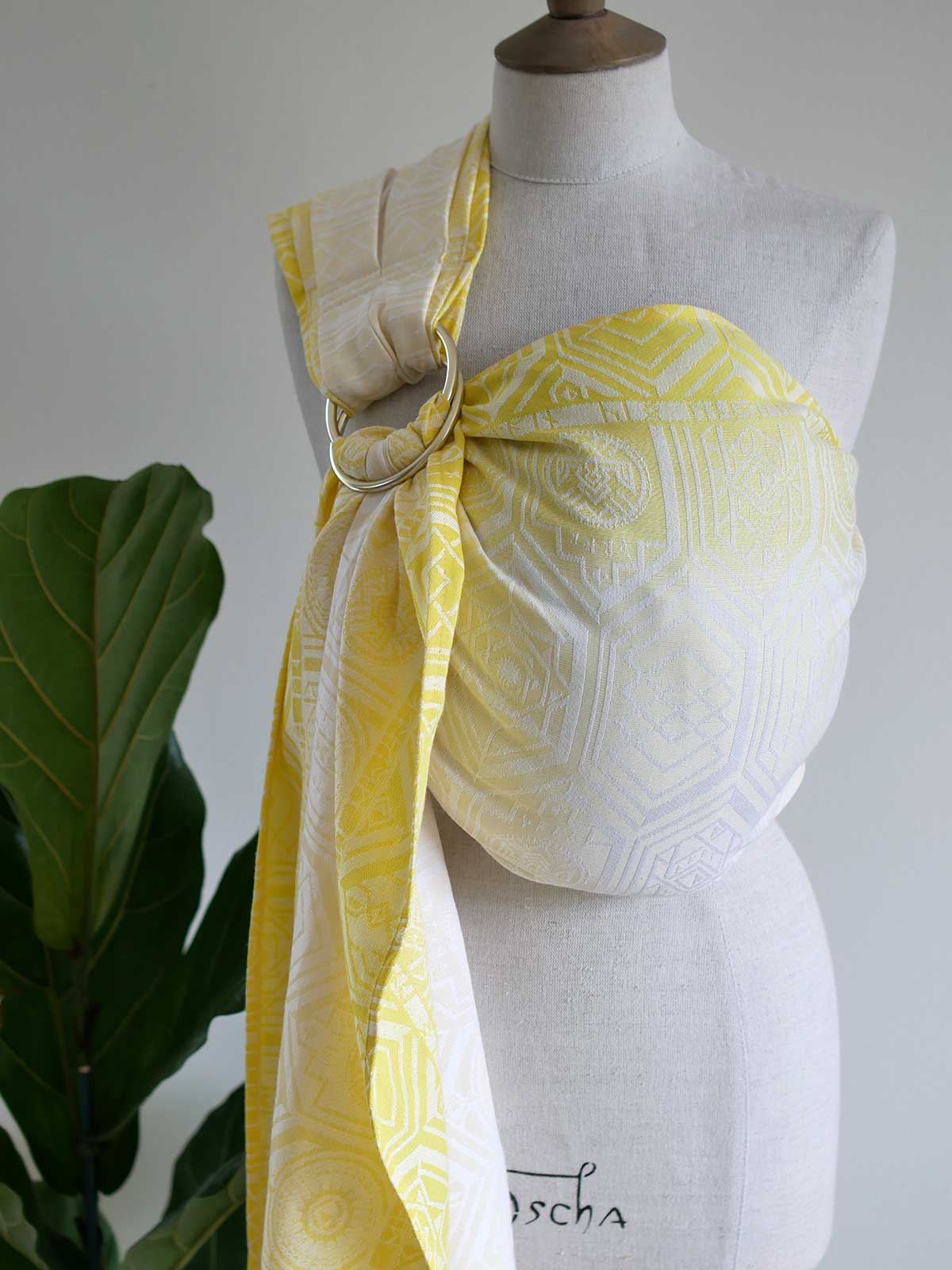 Yellow ring sling with geometric pattern on a mannequin