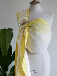 Yellow ring sling with geometric pattern on a mannequin