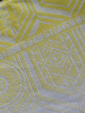Close up of a yellow fabric with geometric pattern