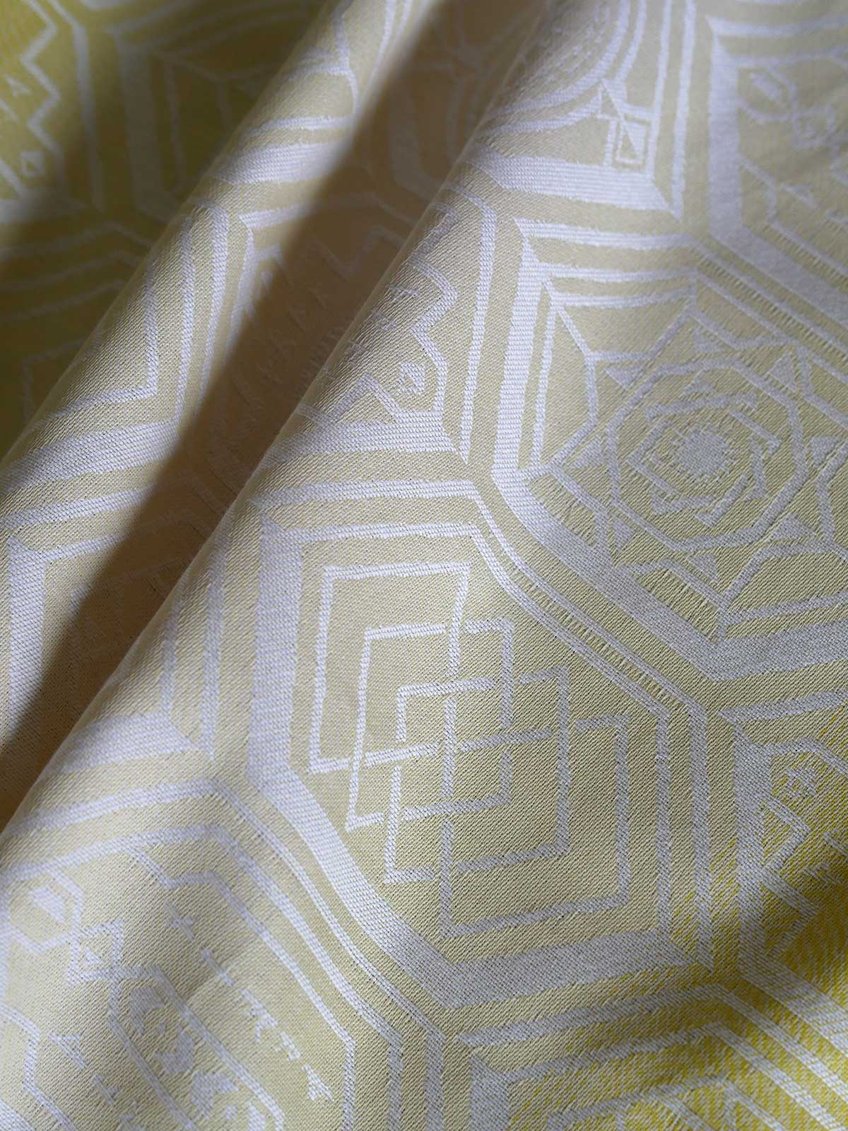 Close up of a yellow fabric with geometric pattern