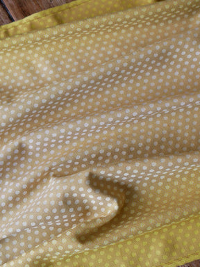 Reverse side of lemon and gold fabric with dots.