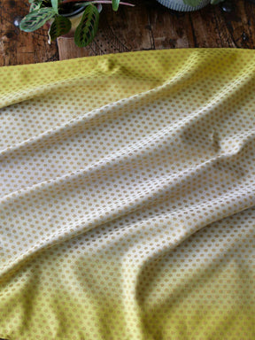 Lemon and gold fabric with dots.