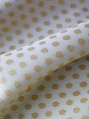 Reverse of lemon and gold fabric with dots.