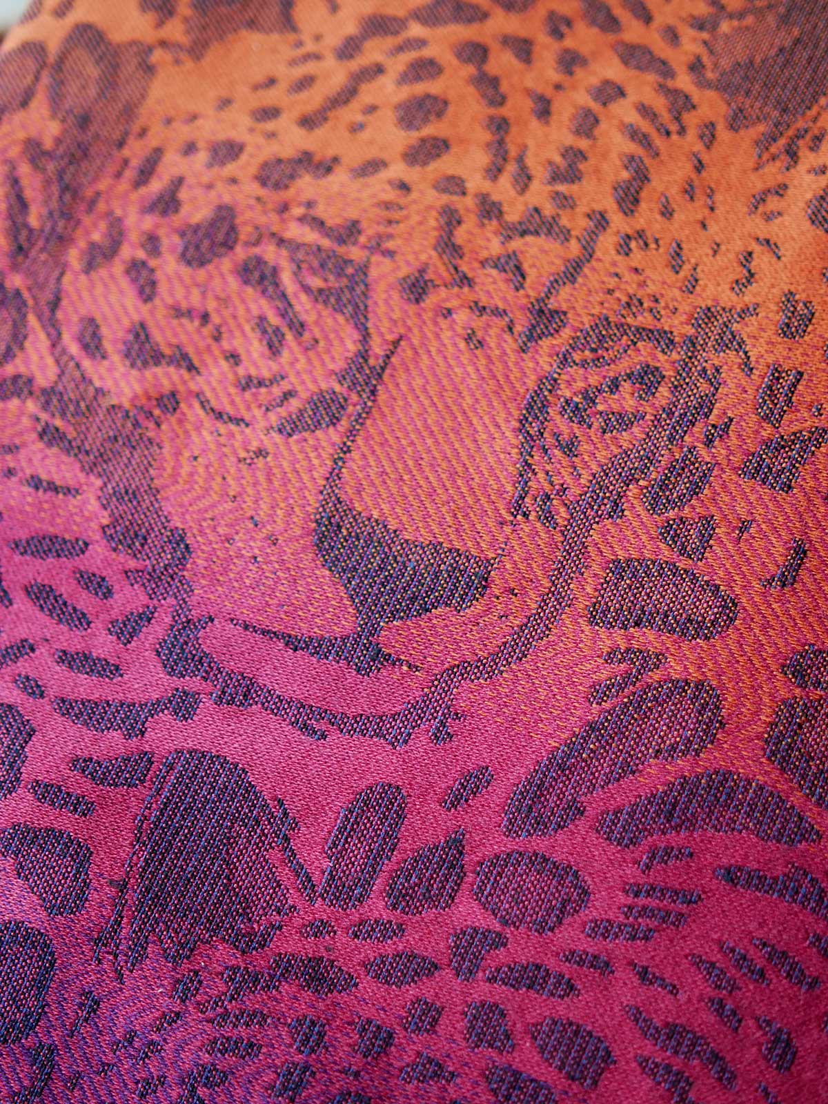 Close up of  fabric with a leopard face in pink.