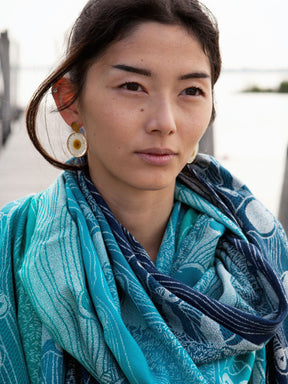 Woman wearing a blue shawl. 