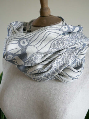 Scarf with blue and white pattern draped over a mannequin bust.