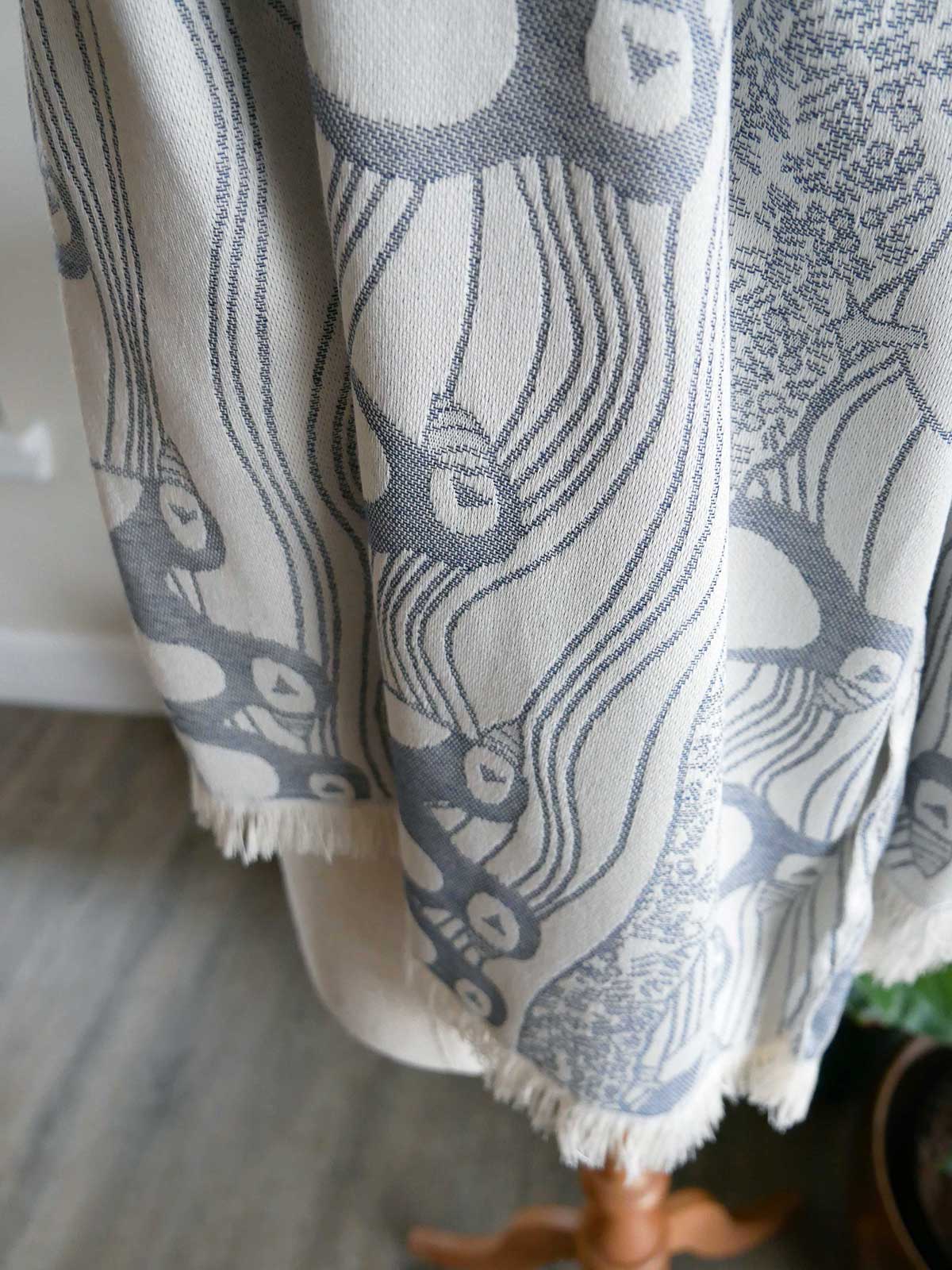 Textile with puffin pattern on a mannequin against neutral background