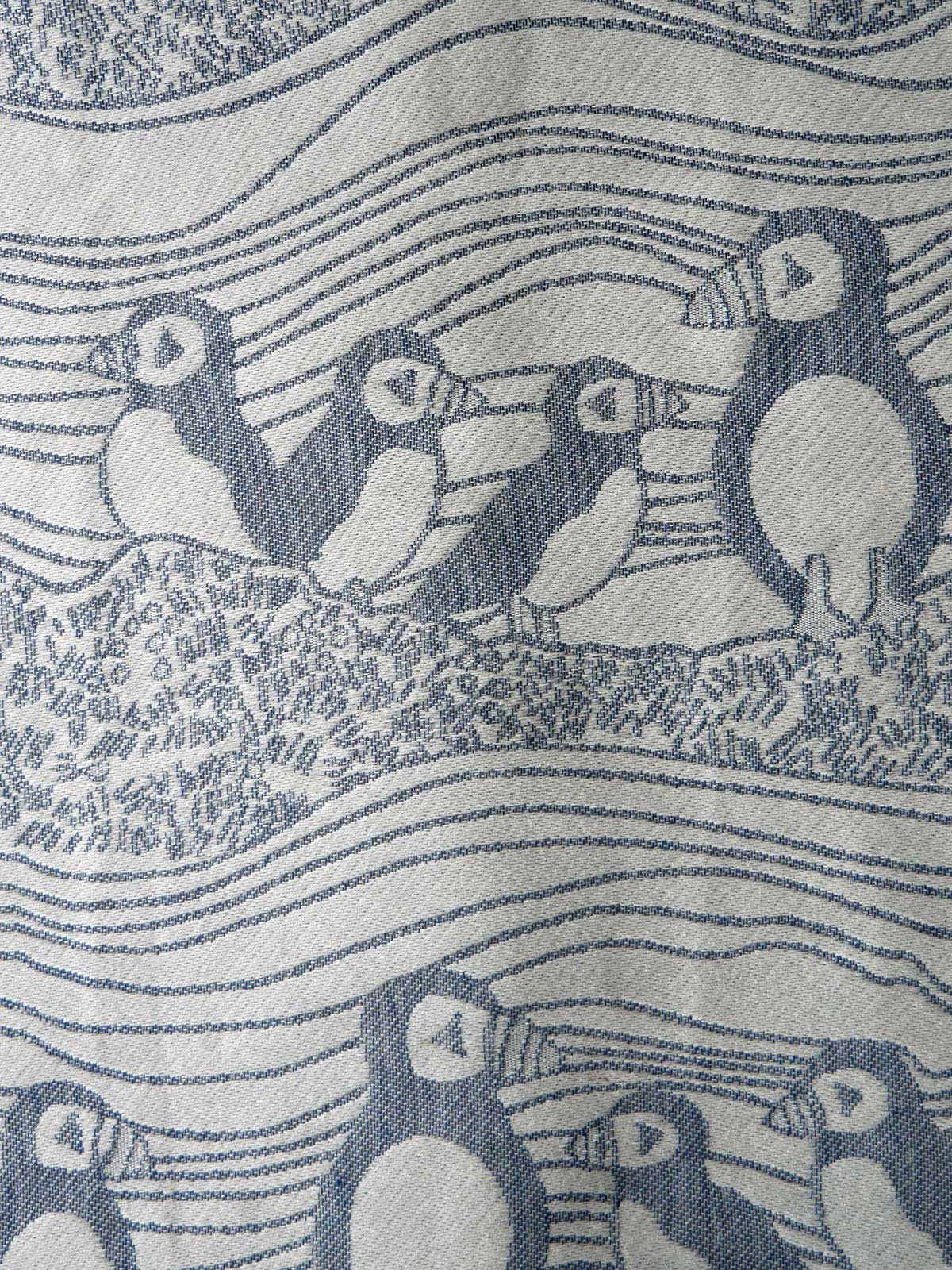 Pattern of puffins on a textured fabric background